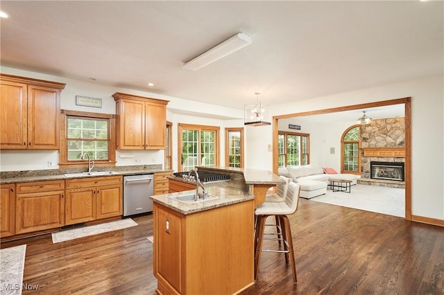 5968 Winchell Rd, Hiram, OH 44234 - kitchen with stainless steel appliances, a sink, a kitchen breakfast bar, open floor plan, and a fireplace