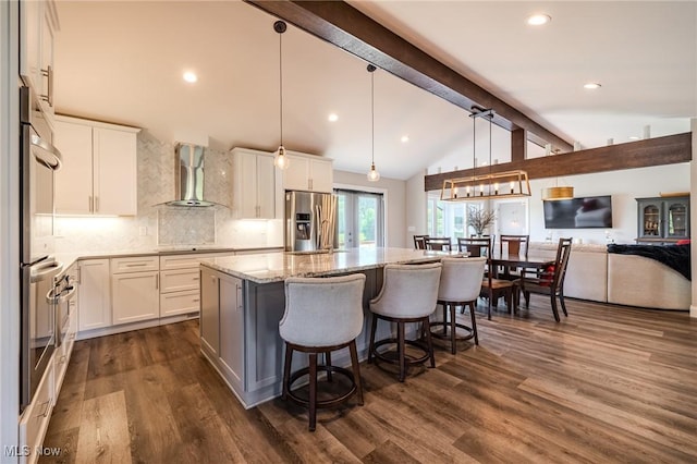 6268 Summers Rd, Windsor, OH 44099 - kitchen featuring wall chimney exhaust hood, stainless steel appliances, light stone countertops, an island with sink, and white cabinetry