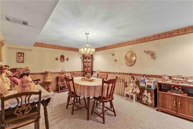 3622 Valacamp Ave SE, Warren, OH 44484 - dining area featuring wainscoting, a chandelier, light carpet, and a textured ceiling