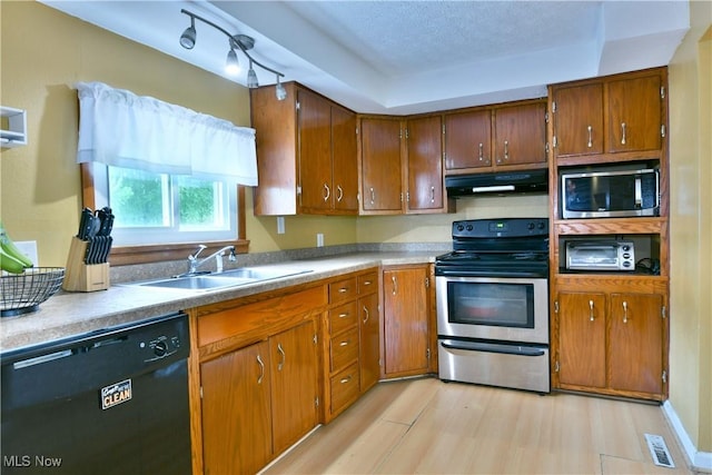 895 Elmwood Dr, Hubbard, OH 44425 - kitchen featuring appliances with stainless steel finishes, ventilation hood, a sink, light wood-style floors, and brown cabinets