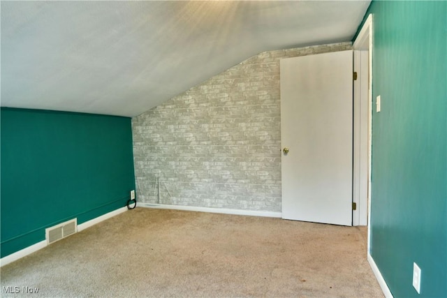 895 Elmwood Dr, Hubbard, OH 44425 - bonus room featuring vaulted ceiling, baseboards, carpet floors, and brick wall
