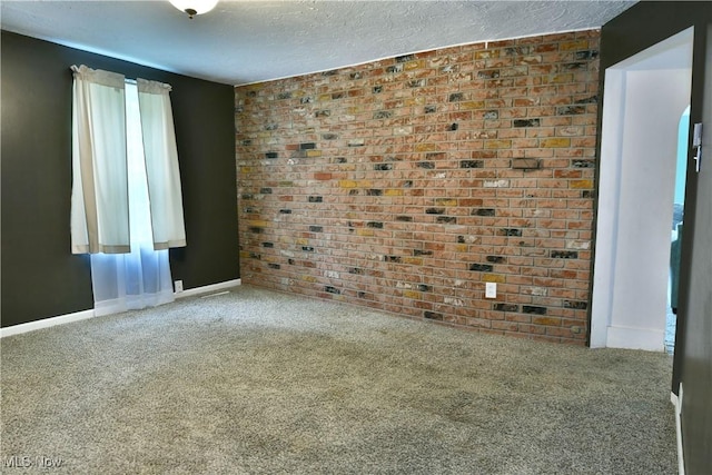 895 Elmwood Dr, Hubbard, OH 44425 - empty room with carpet flooring, baseboards, a textured ceiling, and brick wall