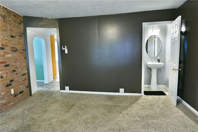 895 Elmwood Dr, Hubbard, OH 44425 - empty room with carpet, baseboards, a textured ceiling, and a sink