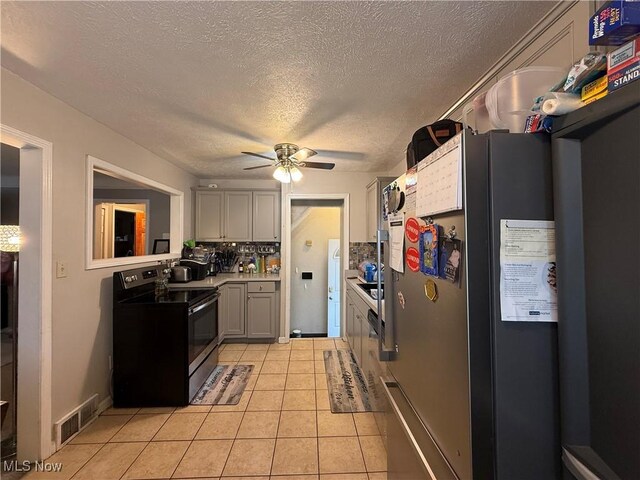 20007 Sunset Dr, Warrensville Heights, OH 44122 - kitchen with appliances with stainless steel finishes, ceiling fan, a textured ceiling, light tile patterned floors, and gray cabinets