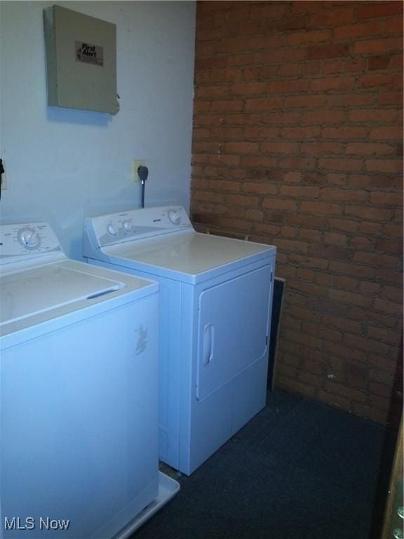 1401 W 75th St Unit D, Cleveland, OH 44102 - washroom featuring separate washer and dryer and brick wall