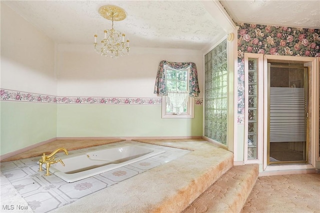 8650 Hidden Hills Dr SE, Howland, OH 44484 - full bathroom featuring a textured ceiling, wallpapered walls, a garden tub, and a chandelier