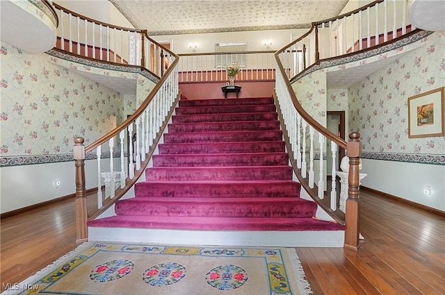 8650 Hidden Hills Dr SE, Howland, OH 44484 - staircase featuring wallpapered walls and hardwood / wood-style floors