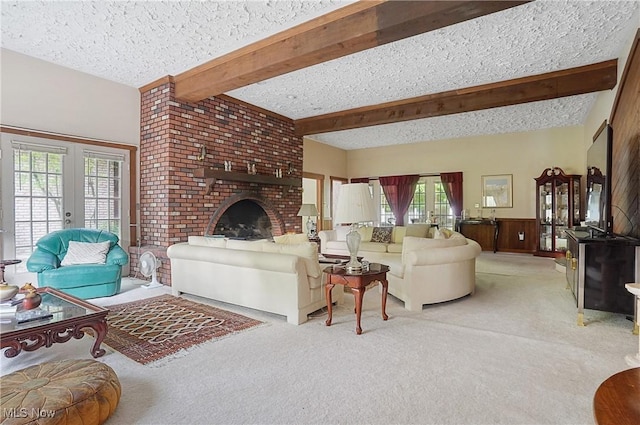 8650 Hidden Hills Dr SE, Howland, OH 44484 - carpeted living area featuring a textured ceiling, beam ceiling, french doors, and a fireplace
