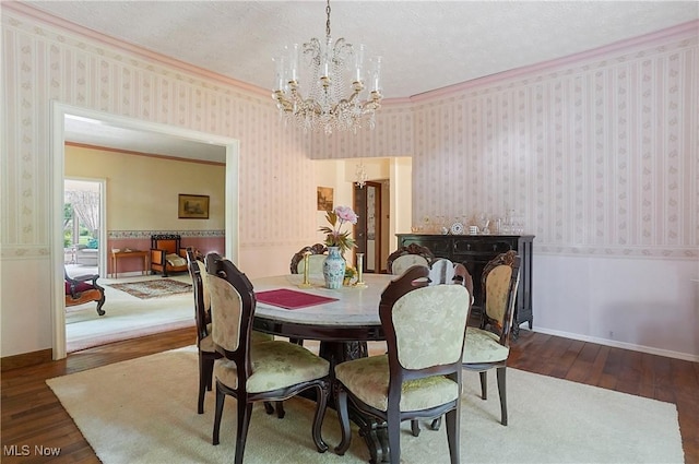 8650 Hidden Hills Dr SE, Howland, OH 44484 - dining space with a chandelier, hardwood / wood-style floors, crown molding, wallpapered walls, and a textured ceiling