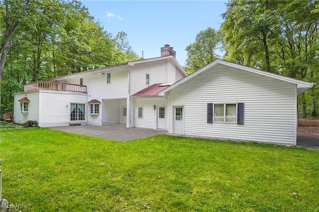 8650 Hidden Hills Dr SE, Howland, OH 44484 - back of property with a chimney, a patio, and a lawn