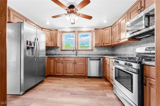 10790 Good Hope Pike, Jane Lew, WV 26378 - kitchen featuring stainless steel appliances, light wood-type flooring, ceiling fan, a sink, and decorative backsplash