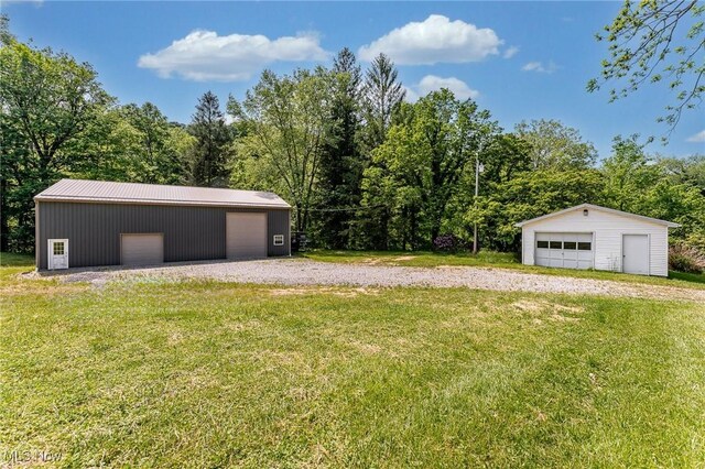10790 Good Hope Pike, Jane Lew, WV 26378 - view of green lawn with a detached garage and an outbuilding