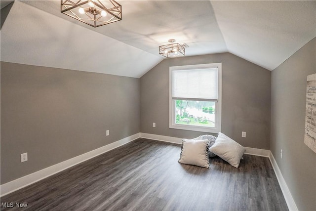 680 Isle View Dr, Akron, OH 44319 - additional living space featuring dark wood-style floors, vaulted ceiling, a chandelier, and baseboards