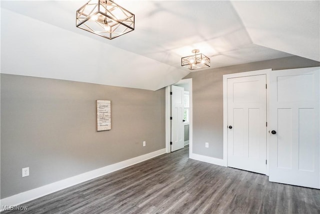 680 Isle View Dr, Akron, OH 44319 - unfurnished bedroom with a chandelier, wood finished floors, baseboards, lofted ceiling, and a closet