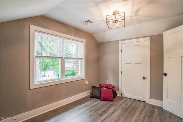 680 Isle View Dr, Akron, OH 44319 - additional living space with wood finished floors, vaulted ceiling, baseboards, and a chandelier