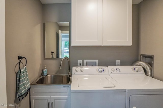 680 Isle View Dr, Akron, OH 44319 - washroom featuring separate washer and dryer and cabinet space