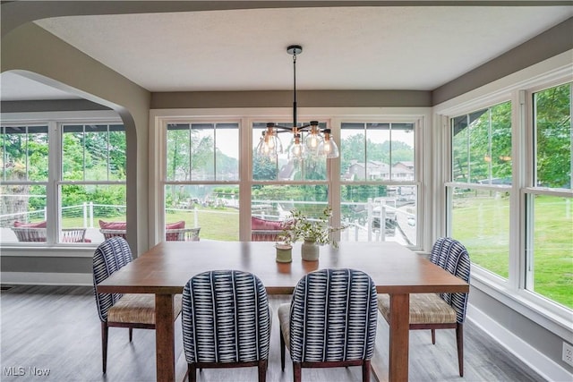 680 Isle View Dr, Akron, OH 44319 - dining space featuring baseboards, a chandelier, and wood finished floors
