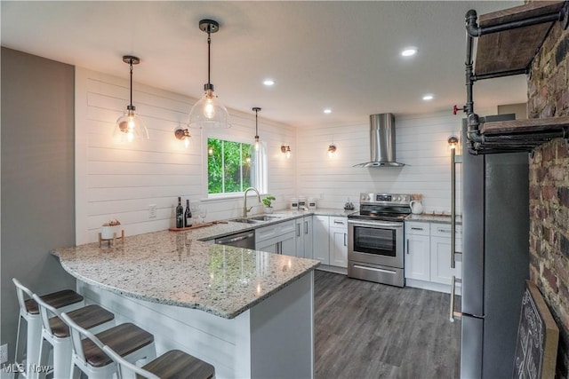 680 Isle View Dr, Akron, OH 44319 - kitchen featuring stainless steel appliances, wall chimney exhaust hood, a sink, a peninsula, and dark wood-style floors