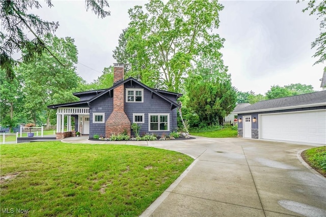 680 Isle View Dr, Akron, OH 44319 - view of front of house with a chimney, concrete driveway, a front yard, and a garage