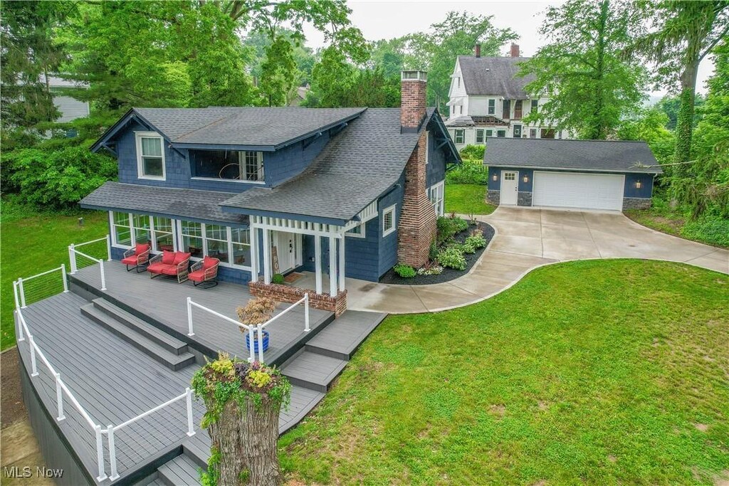 680 Isle View Dr, Akron, OH 44319 - view of front of house featuring a shingled roof, a wooden deck, an outdoor living space, a front lawn, and a chimney