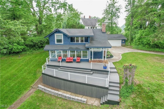 680 Isle View Dr, Akron, OH 44319 - view of front of property featuring roof with shingles, outdoor lounge area, a front lawn, and a chimney