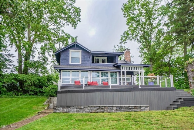 680 Isle View Dr, Akron, OH 44319 - rear view of property with a lawn, stairs, a chimney, and a wooden deck