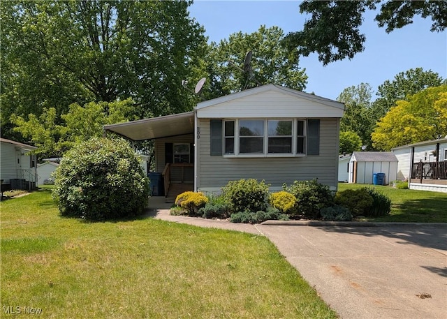 200 E St SW, Navarre, OH 44662 - view of front of house featuring a front lawn, an attached carport, and central air condition unit