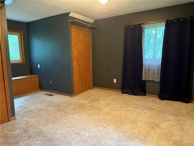 7687 Galena St NW, Massillon, OH 44646 - unfurnished bedroom with carpet flooring, baseboards, and a textured ceiling