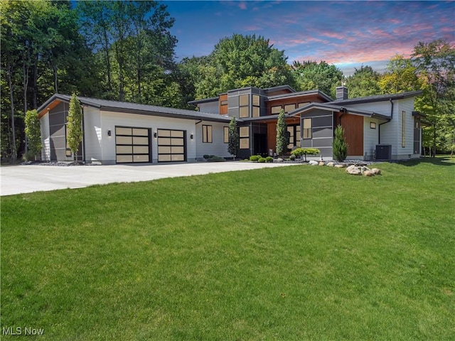 4385 Good Rd, Seville, OH 44273 - contemporary home featuring a garage, driveway, a front lawn, central AC, and a chimney
