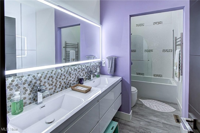 4385 Good Rd, Seville, OH 44273 - full bathroom featuring a towel warming rack, toilet, double vanity, and wood finished floors