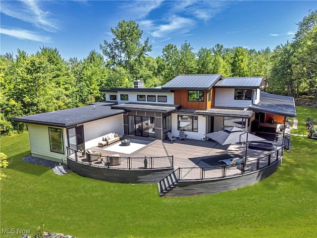 4385 Good Rd, Seville, OH 44273 - rear view of house with a deck, a lawn, a chimney, and view of scattered trees