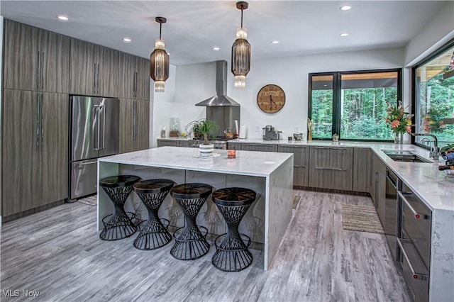 4385 Good Rd, Seville, OH 44273 - kitchen featuring high end refrigerator, modern cabinets, wall chimney range hood, a sink, and light wood-style floors