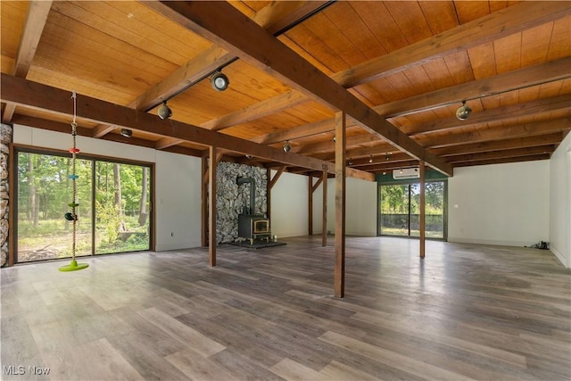 6226 Mayburn Barclay Rd, Kinsman, OH 44428 - unfurnished living room featuring track lighting, wood ceiling with exposed beams, wood finished floors, a wood stove, and baseboards