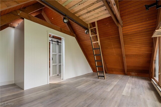 6226 Mayburn Barclay Rd, Kinsman, OH 44428 - spare room with a baseboard radiator, wood ceiling, wood finished floors, and a barn door