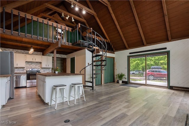 6226 Mayburn Barclay Rd, Kinsman, OH 44428 - kitchen featuring appliances with stainless steel finishes, white cabinets, wood ceiling with exposed beams, wooden counters, and light wood-type flooring