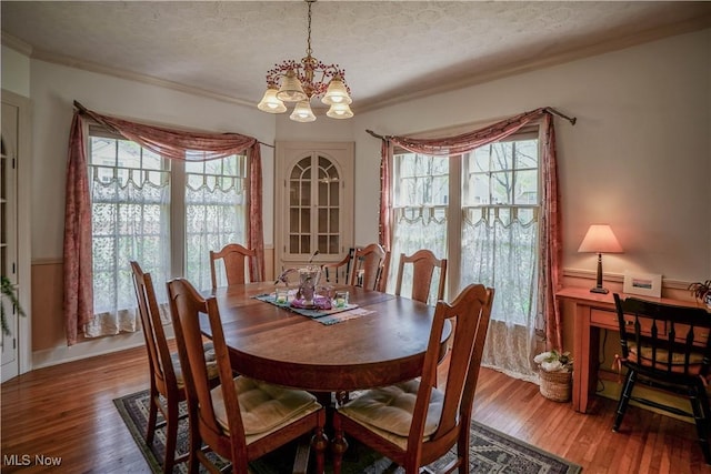 1415 Inwood Rd, Alliance, OH 44601 - dining area with a chandelier, ornamental molding, wood finished floors, and a textured ceiling