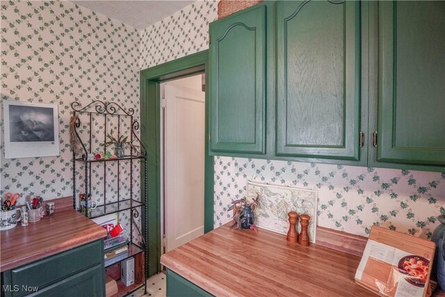 1415 Inwood Rd, Alliance, OH 44601 - kitchen featuring wallpapered walls, green cabinets, and wooden counters