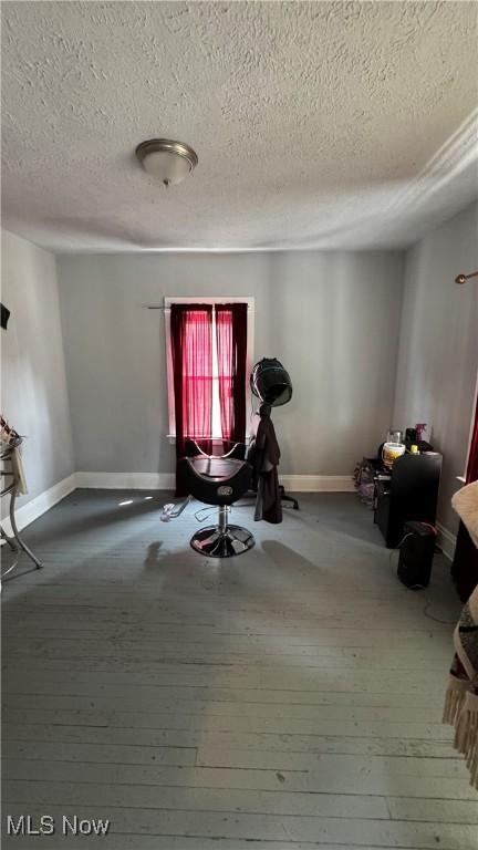 3415 E 114th St, Cleveland, OH 44104 - exercise room with a textured ceiling, baseboards, and wood-type flooring