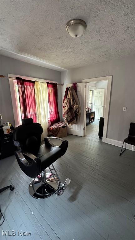 3415 E 114th St, Cleveland, OH 44104 - living area with a textured ceiling, hardwood / wood-style floors, and baseboards