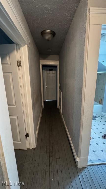 3415 E 114th St, Cleveland, OH 44104 - hallway featuring dark wood-style floors, a textured ceiling, and baseboards