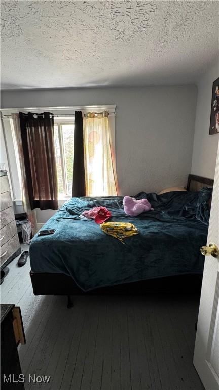 3415 E 114th St, Cleveland, OH 44104 - bedroom featuring hardwood / wood-style floors and a textured ceiling