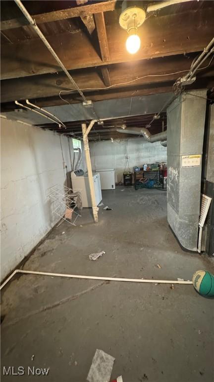 3415 E 114th St, Cleveland, OH 44104 - unfinished below grade area featuring washer / clothes dryer and heating unit