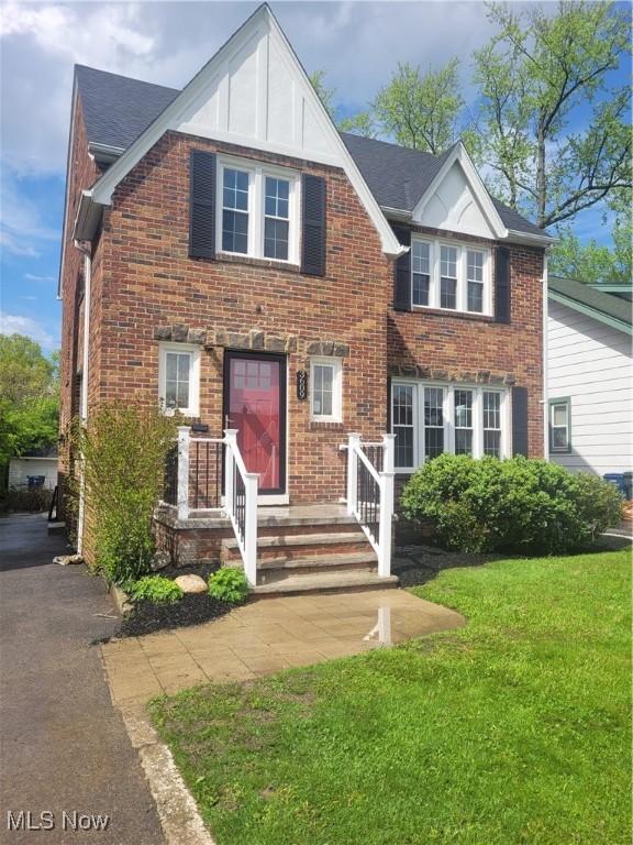3609 Antisdale Ave, Cleveland Heights, OH 44118 - tudor house featuring a front yard, brick siding, and a shingled roof