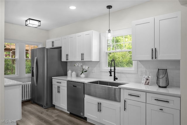3609 Antisdale Ave, Cleveland Heights, OH 44118 - kitchen with radiator, stainless steel appliances, a sink, white cabinetry, and light countertops