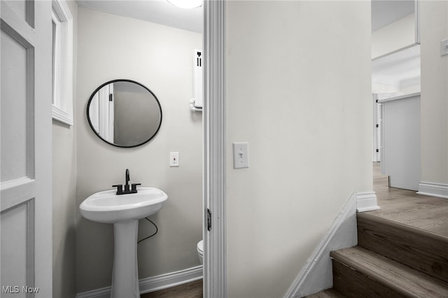 3609 Antisdale Ave, Cleveland Heights, OH 44118 - half bathroom featuring toilet, wood finished floors, a sink, and baseboards