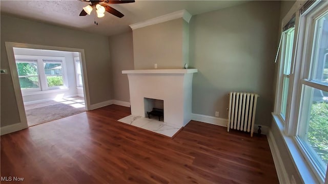 1901 Parkway Dr, Cleveland Heights, OH 44118 - unfurnished living room with radiator heating unit, wood finished floors, ceiling fan, baseboards, and ornamental molding