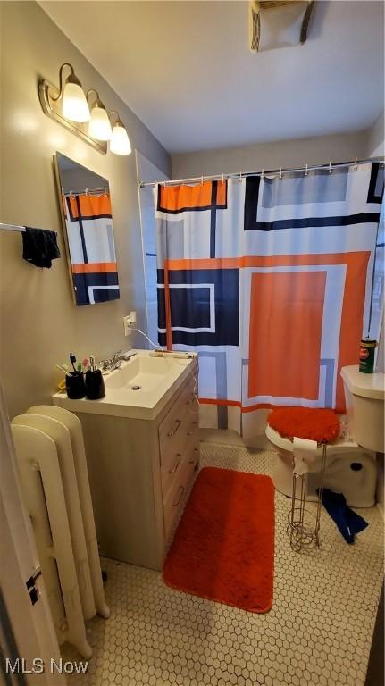 1901 Parkway Dr, Cleveland Heights, OH 44118 - full bathroom with radiator, vanity, and toilet