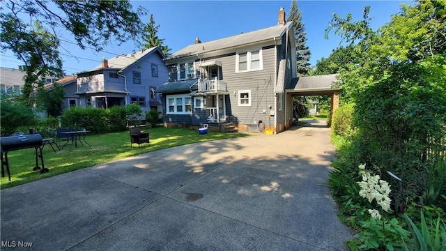 1901 Parkway Dr, Cleveland Heights, OH 44118 - back of house with driveway, an attached carport, a chimney, a yard, and a balcony