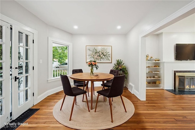3020 E Derbyshire Rd, Cleveland Heights, OH 44118 - dining area with light wood-style floors, a fireplace with flush hearth, baseboards, recessed lighting, and french doors