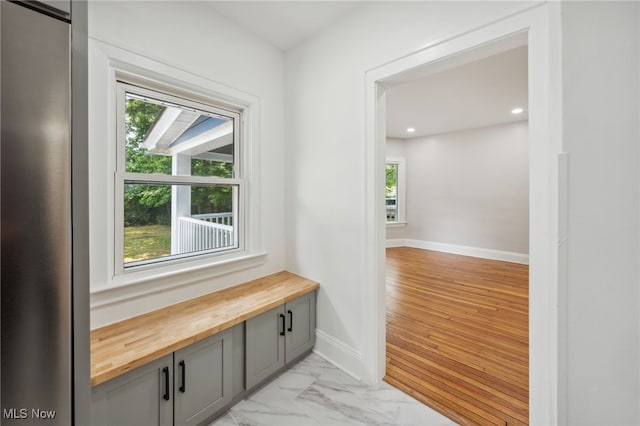 3020 E Derbyshire Rd, Cleveland Heights, OH 44118 - hallway with healthy amount of natural light, recessed lighting, baseboards, and light marble finish flooring